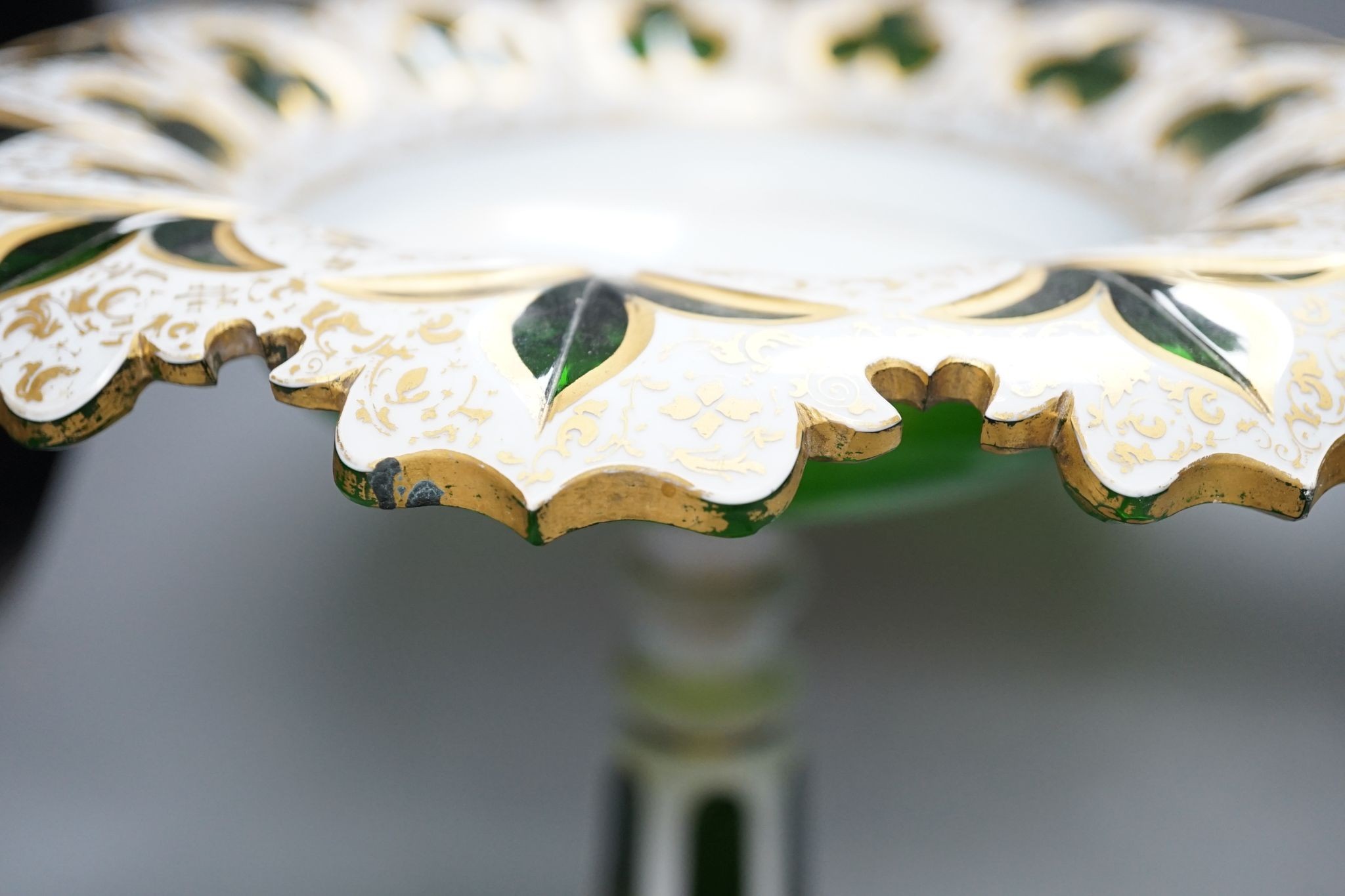 A 19th century overlaid green glass comport, 24cm high, and a similar table lustre